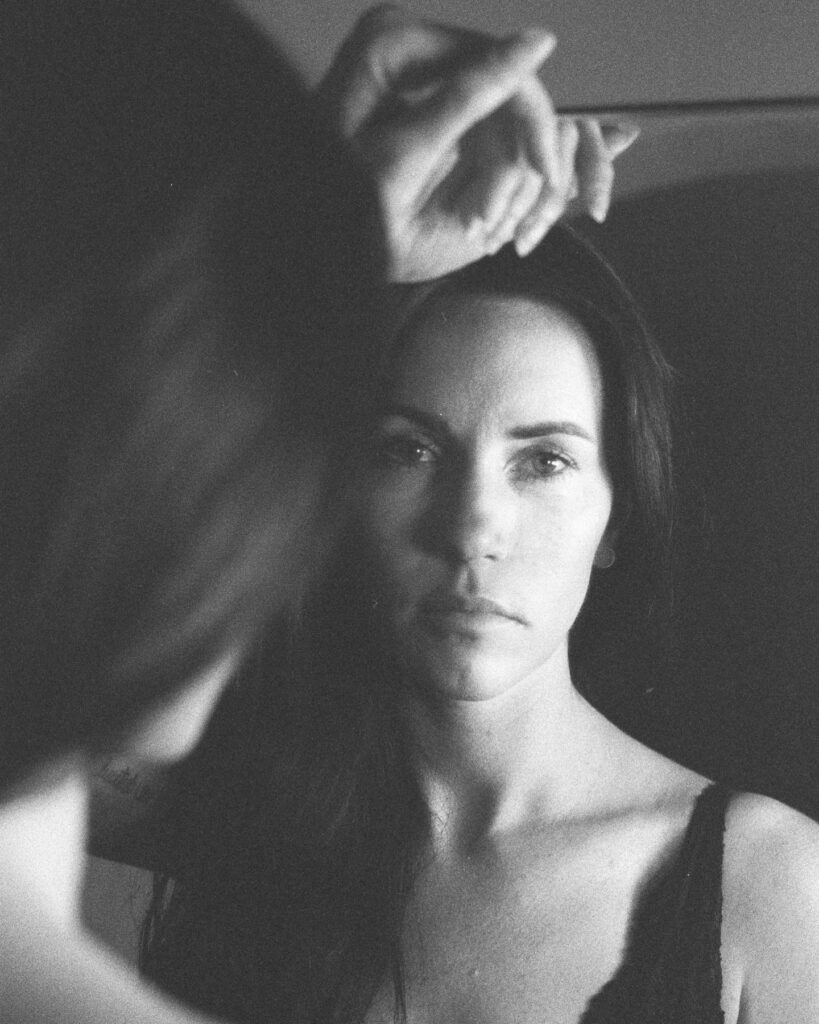 Black and white image of a woman in a mirror 