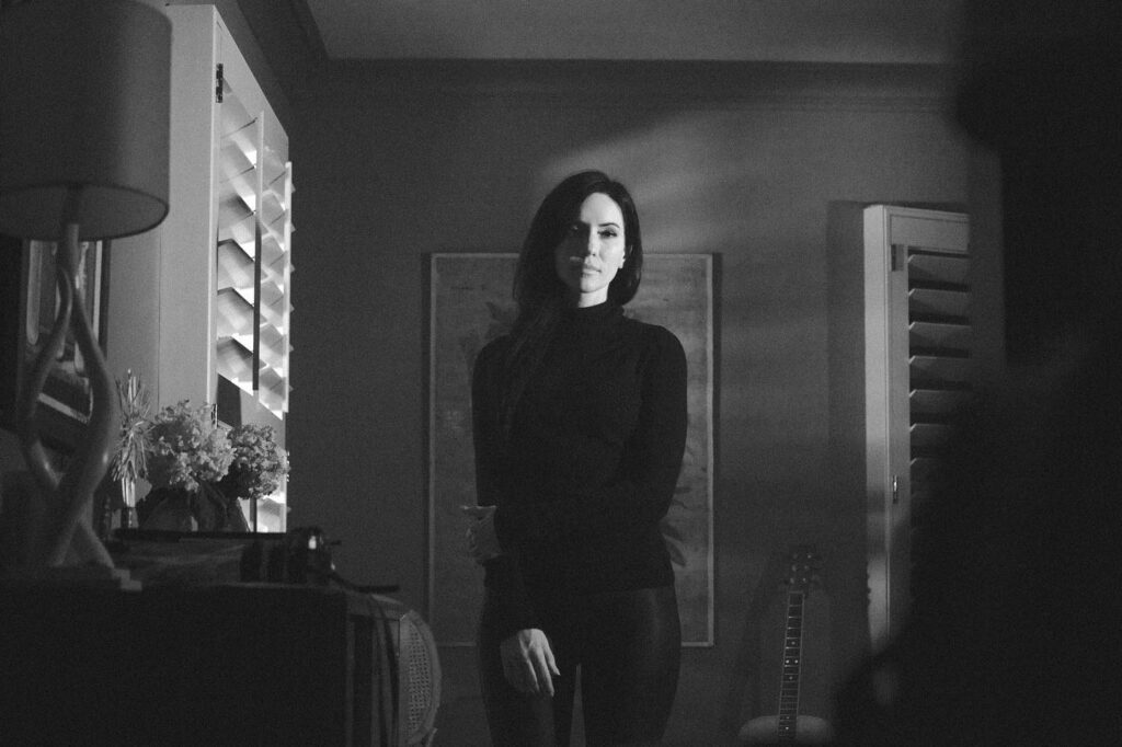 Black and white image of woman in a room