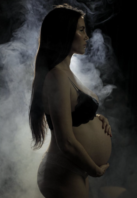 Picture of pregnant woman holding her belly. 