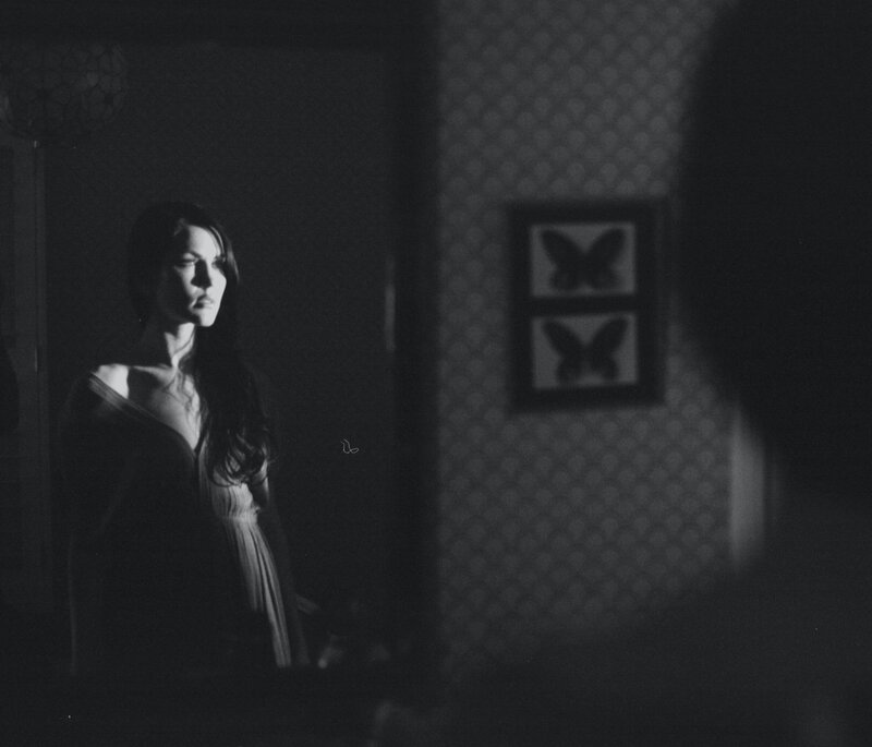 Black and white image of woman in a dark room